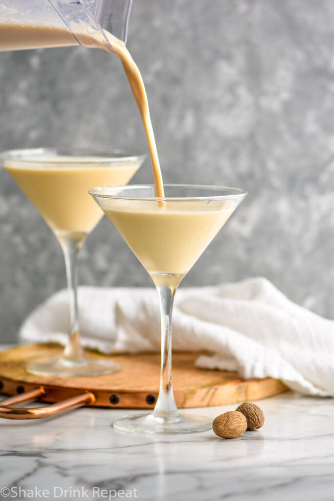 blender of Brandy Alexander Ice Cream ingredients pouring into a martini glass