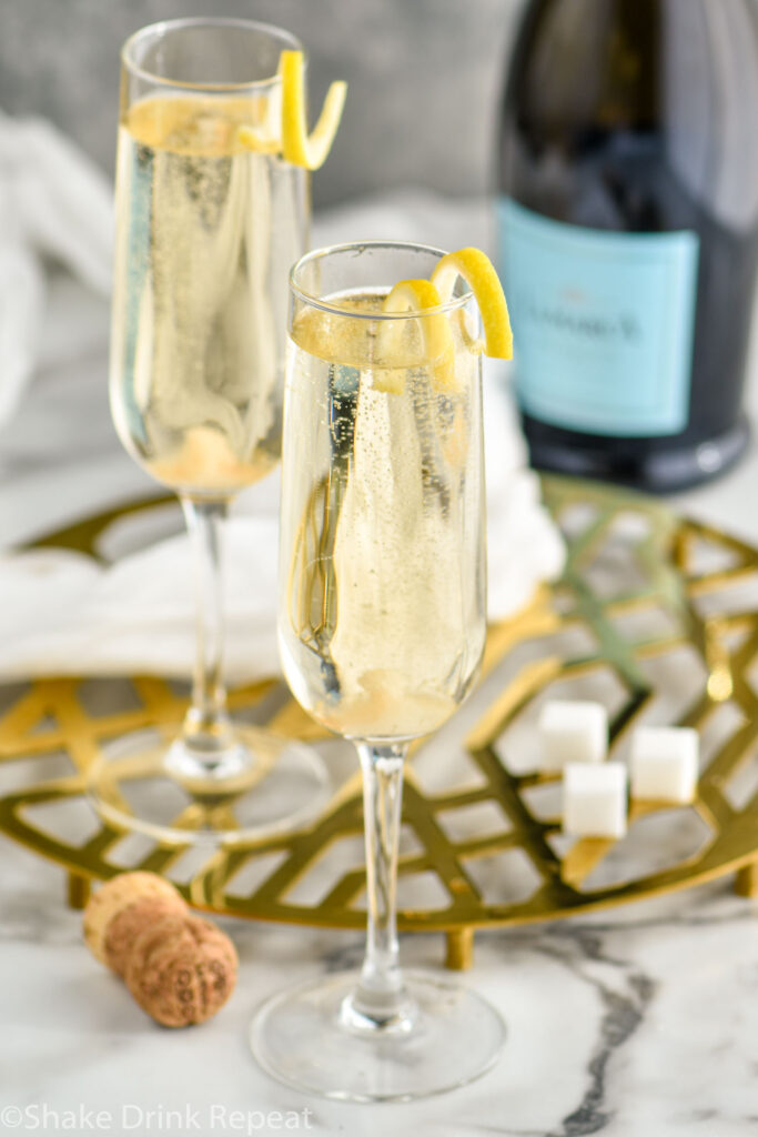 overhead view of two champagne flutes filled with a champagne and vodka cocktail