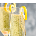 Two glasses of Champagne Cocktail garnished with a lemon twist