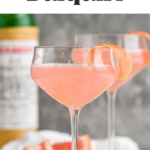Two glasses of Hemingway Daiquiri recipe garnished with grapefruit twist with bottle of Luxardo in the background
