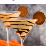 two martini glasses of Peanut Butter Cup Martini recipe garnished with chocolate drizzle and a peanut butter cup.