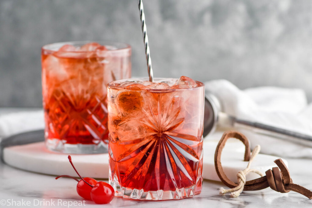 two glasses of Shirley Temple Black with ice and maraschino cherries