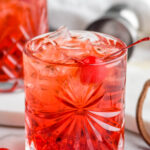 two glasses of Shirley Temple Black with ice and maraschino cherries