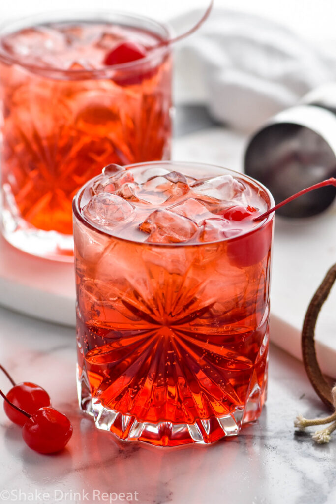 two glasses of Shirley Temple Black drink with ice and maraschino cherries