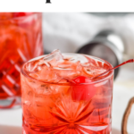 glass of Shirley Temple Black with ice and maraschino cherries