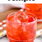 Close up of glass of Shirley Temple drink with ice and garnished with a cherry