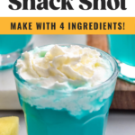 shot glass of Blue Scooby Snack Shot recipe topped with whipped cream