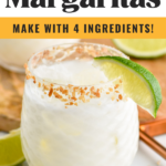 Glass of Coconut Margarita with ice and toasted coconut rim with garnished with lime wedge