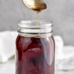 Jar of homemade Demerara Syrup with spoon coming out of jar