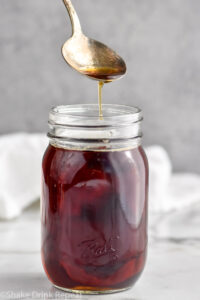 Jar of homemade Demerara Syrup with spoon coming out of jar
