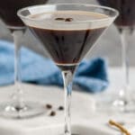 three martini glasses of Espresso Martini garnished with espresso beans