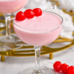 two coupe classes of Pink Squirrel cocktails garnished with three cherries