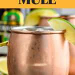 Pinterest graphic of Moscow Mule. Image shows copper mug of moscow mule recipe garnished with a lime with bottles of ginger beer in background. Text says "vodka Moscow Mule shakedrinkrepeat.com"