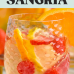 pinterest graphic of white sangria. Text says "white sangria so easy! shakedrinkrepeat.com" image shows a glass of white sangria garnished with fruit with fresh strawberry and raspberries laying beside