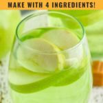 pinterest graphic of caramel apple sangria. Text says "caramel apple sangria so easy! Make with 4 ingredients! shakedrinkrepeat.com" Image shows wine glass of caramel apple sangria with fresh apple slices surrounded by caramel candies