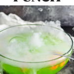Pinterest graphic of Monster Punch. Text says "The best monster punch shakedrinkrepeat.com" Image shows a punch bowl of Halloween punch with ladle, dry ice, and toy eye balls.