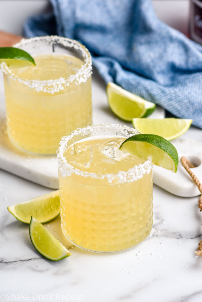 Photo of Grand Marnier Margarita served in a glass of ice with a salted rim and a lime wedge as garnish.