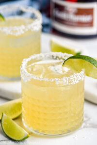 Photo of Grand Marnier Margarita served in a glass of ice with a salted rim and a lime wedge as garnish.