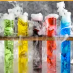 pinterest graphic of mad scientist shots. Text says "vodka made scientist shots shakedrinkrepeat.com" image shows five test tubes of mad scientist shots with dry ice in wooden holder