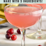 Pinterest graphic of cranberry daiquiri. Text says "cranberry daiquiri rum make with 3 ingredients! shakedrinkrepeat.com" Image shows a glass of cranberry daiquiri with cranberries laying beside glass
