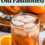 Pinterest graphic of Fall spiced old fashioned. Text says "falls spiced old fashioned so easy! shakedrinkrepeat.com" Image shows glass of fall spiced old fashioned with ice and garnished with cinnamon stick, orange slices and cinnamon sticks sitting beside.