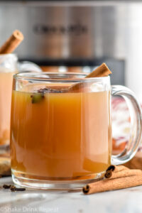 mug of spiced apple cider garnished with a cinnamon stick and star anise