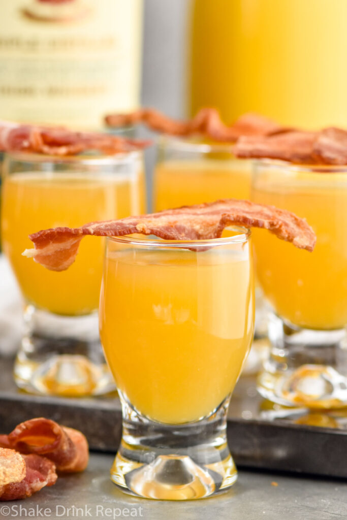 shot glasses of breakfast shot recipe topped with bacon