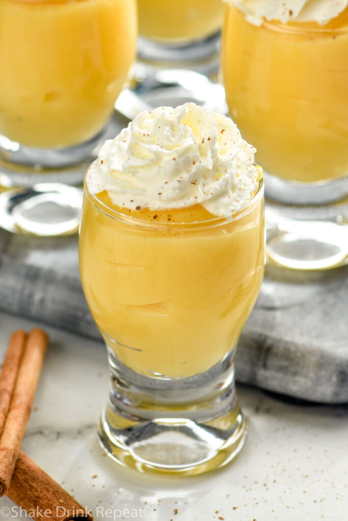 Overhead photo of RumChata Pudding Shots garnished with whipped cream.