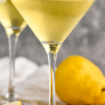 Pinterest graphic of Pear Martini with a front facing photo of the martini with a whole pear to the right of it. Says, 'The Best Pear Martini, shakedrinkrepeat.com'
