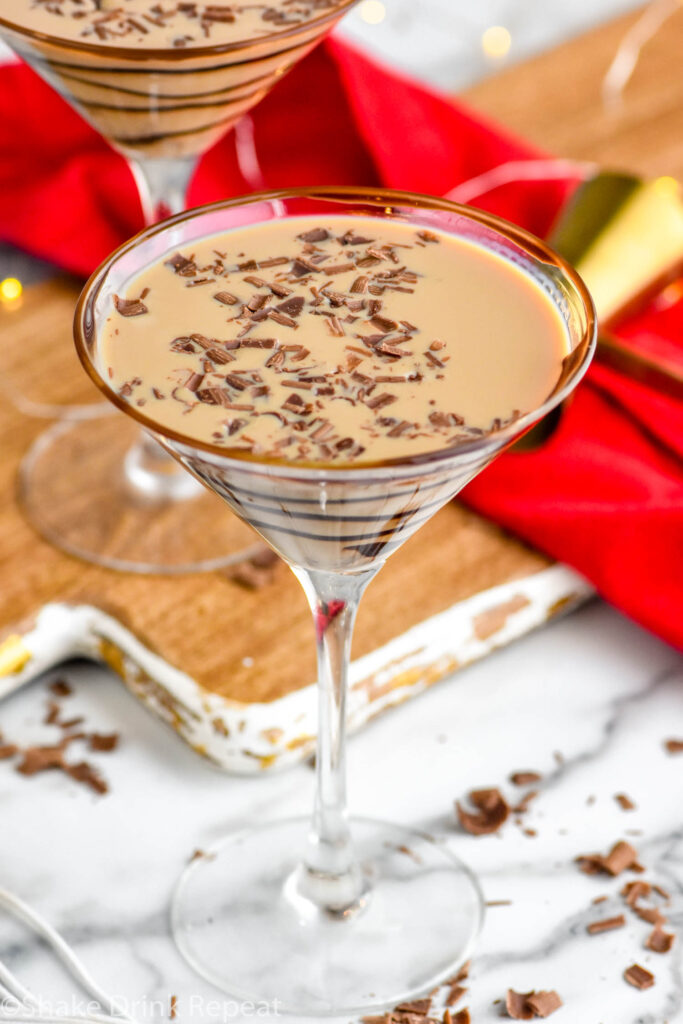 Overhead photo of Chocolate Martini in a chocolate drizzled martini glass with chocolate shavings.
