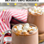 pinterest graphic for crockpot hot chocolate. Text says "the best crockpot hot chocolate only uses 7 ingredients! shakedrinkrepeat.com" Image shows two mugs of crockpot hot chocolate topped with marshmallows.