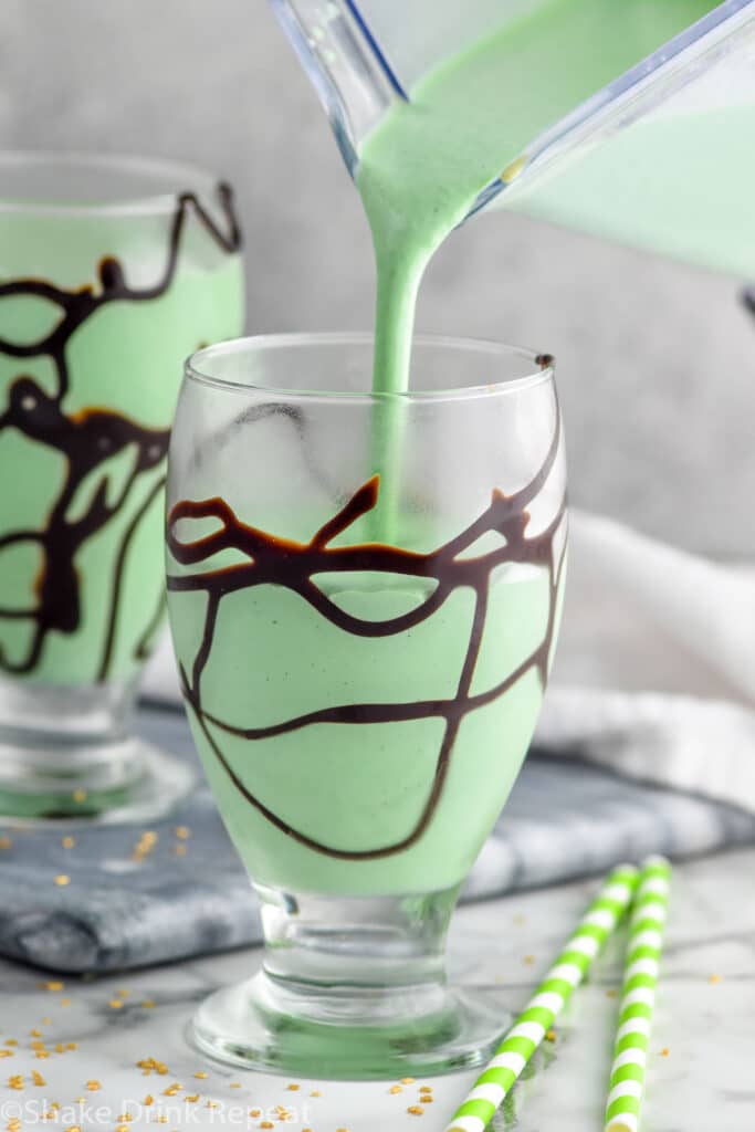 Photo of St. Patrick's Day Mudslide being poured into a glass with chocolate drizzle.