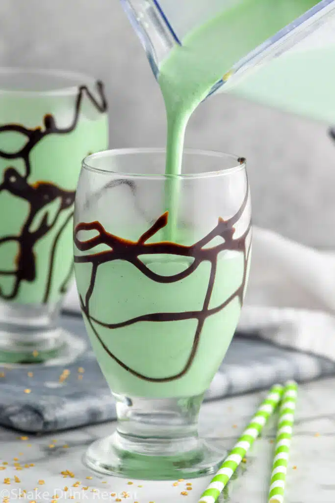 Photo of St. Patrick's Day Mudslide being poured into a glass with chocolate drizzle.