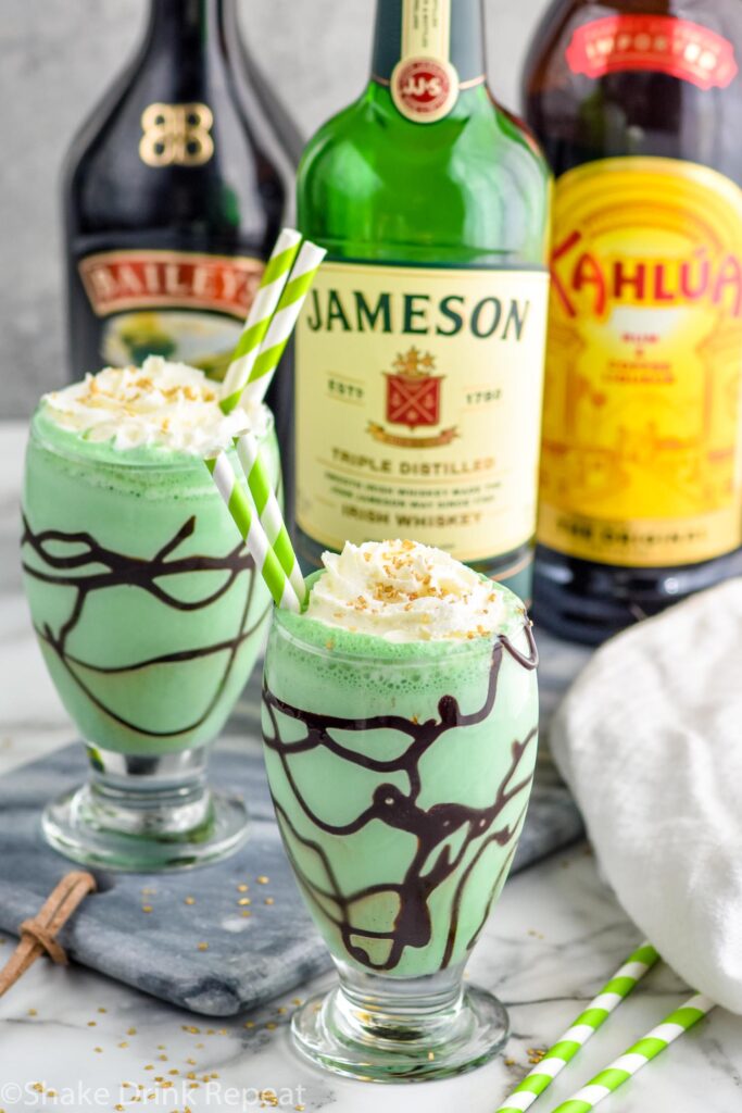 Photo of St. Patrick's Day Mudslides. Bottles of Baileys, Jameson, and Kahlua in the background.