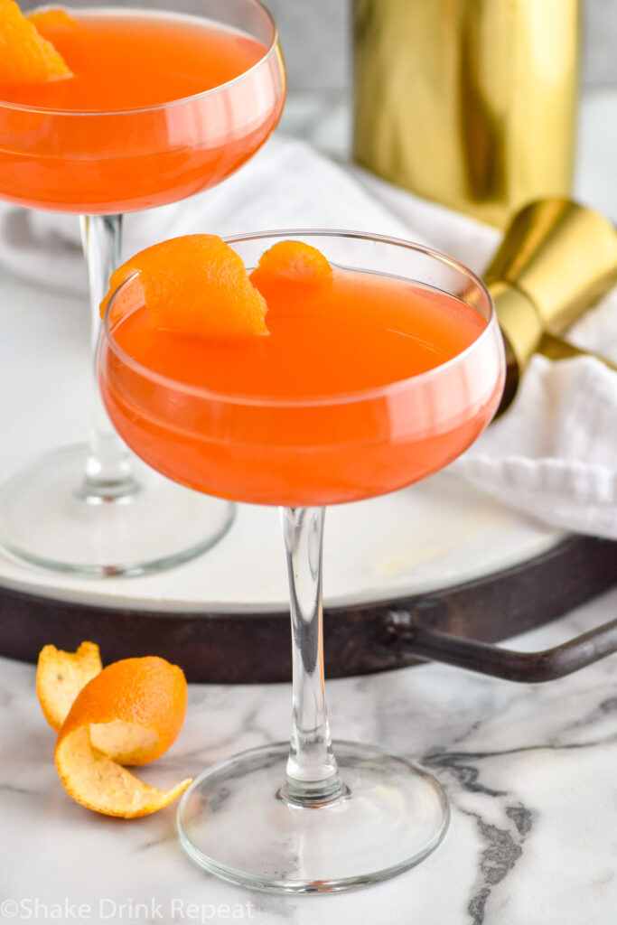 Overhead photo of Paper Plane cocktails garnished with an orange peel.