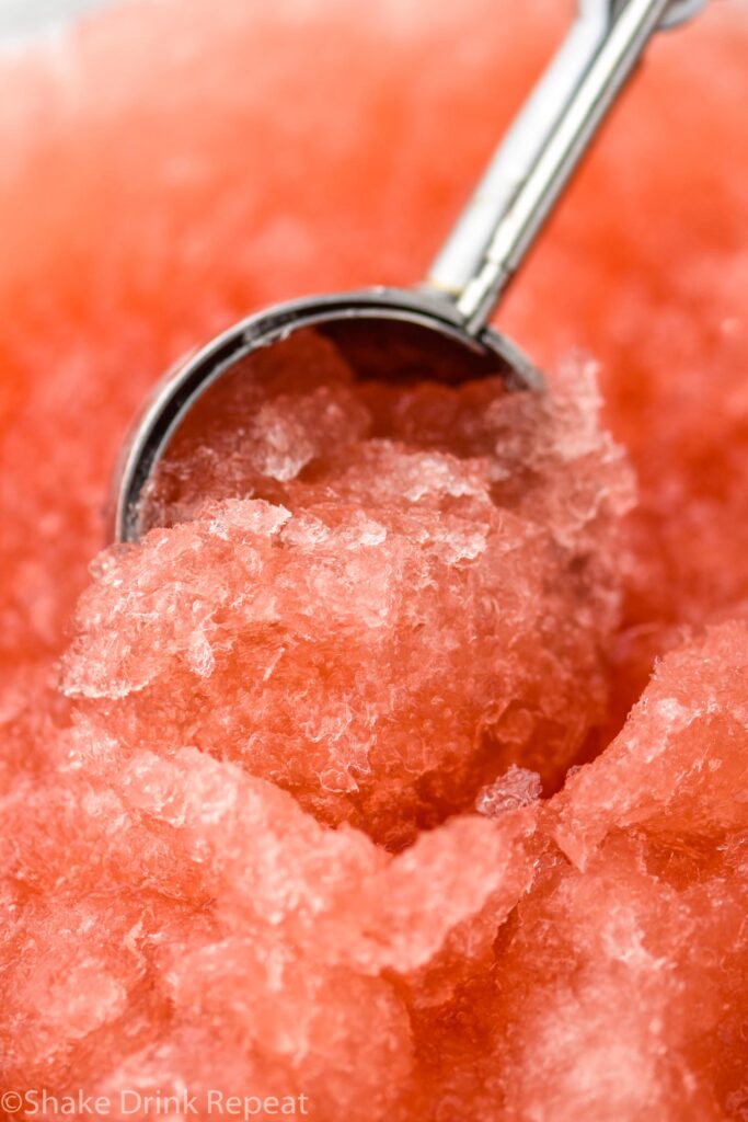 Close up photo of a cookie scoop dipping into Dirty Shirley Slush.