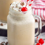 Photo of Bushwacker cocktail served in a glass mug garnished with cherries and straws