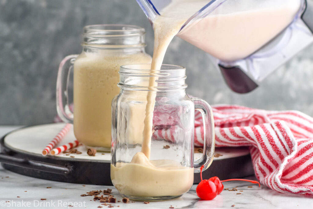 Side view of blended Bushwacker recipe being poured into mugs