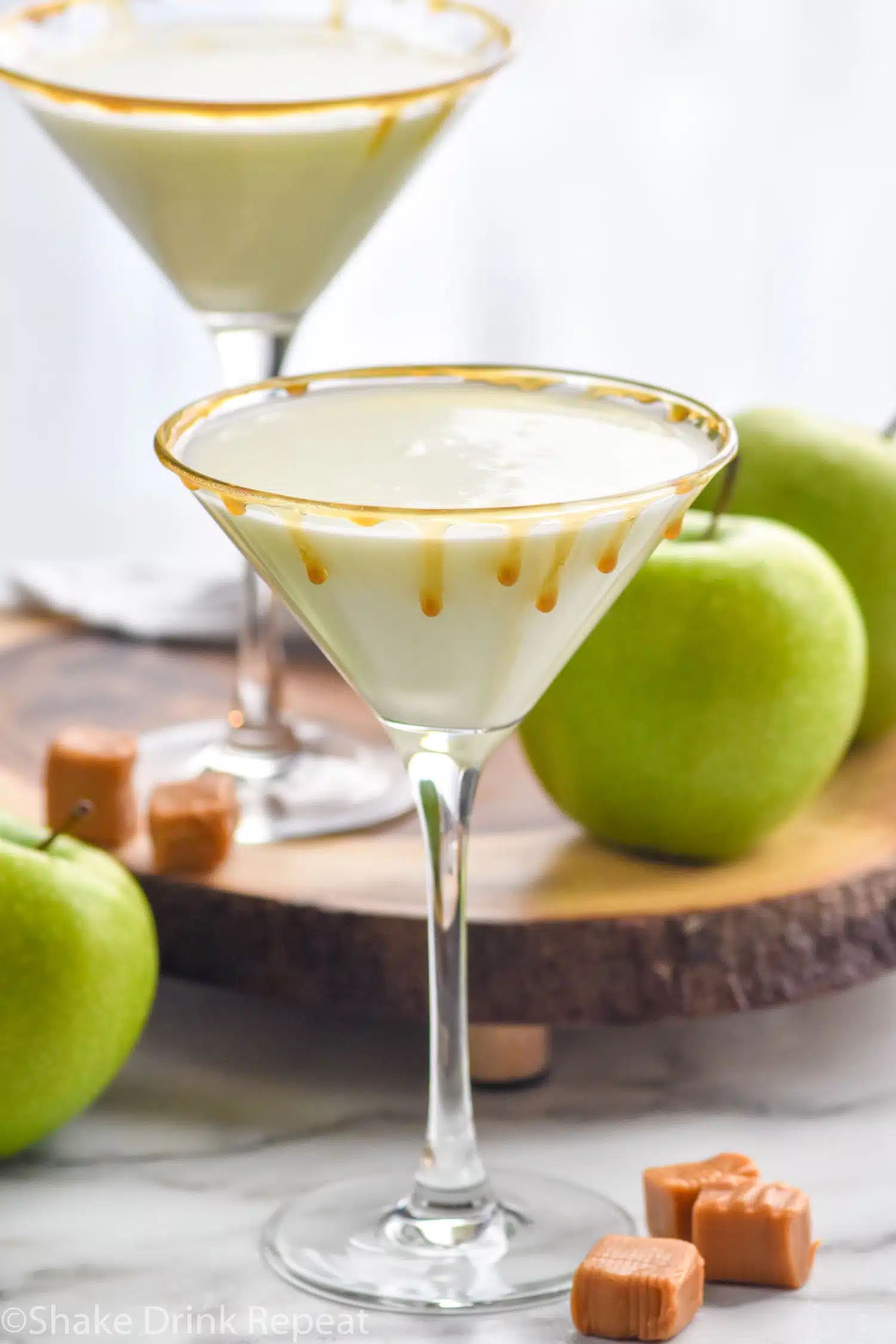 Photo of Creamy Caramel Apple Martini with apples and caramels beside