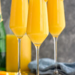 Side view of Non Alcoholic Mimosas garnished with orange slices