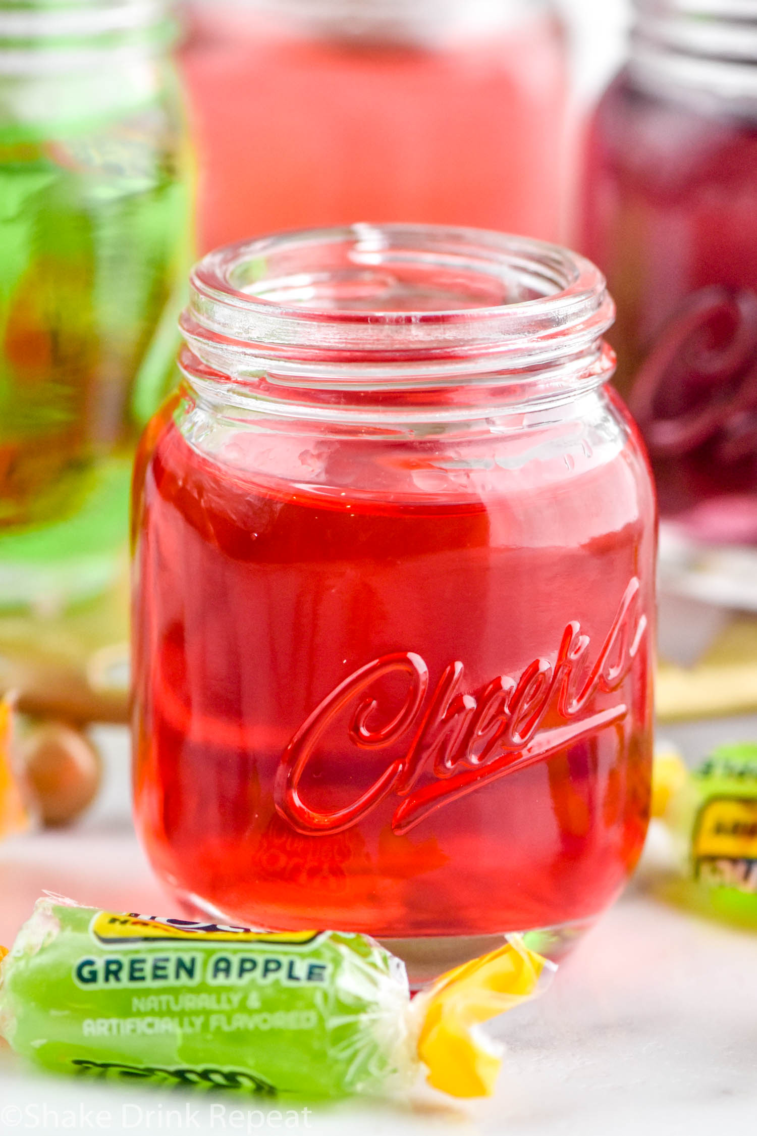 Photo of red Jolly Rancher Shot with Jolly Rancher candies beside