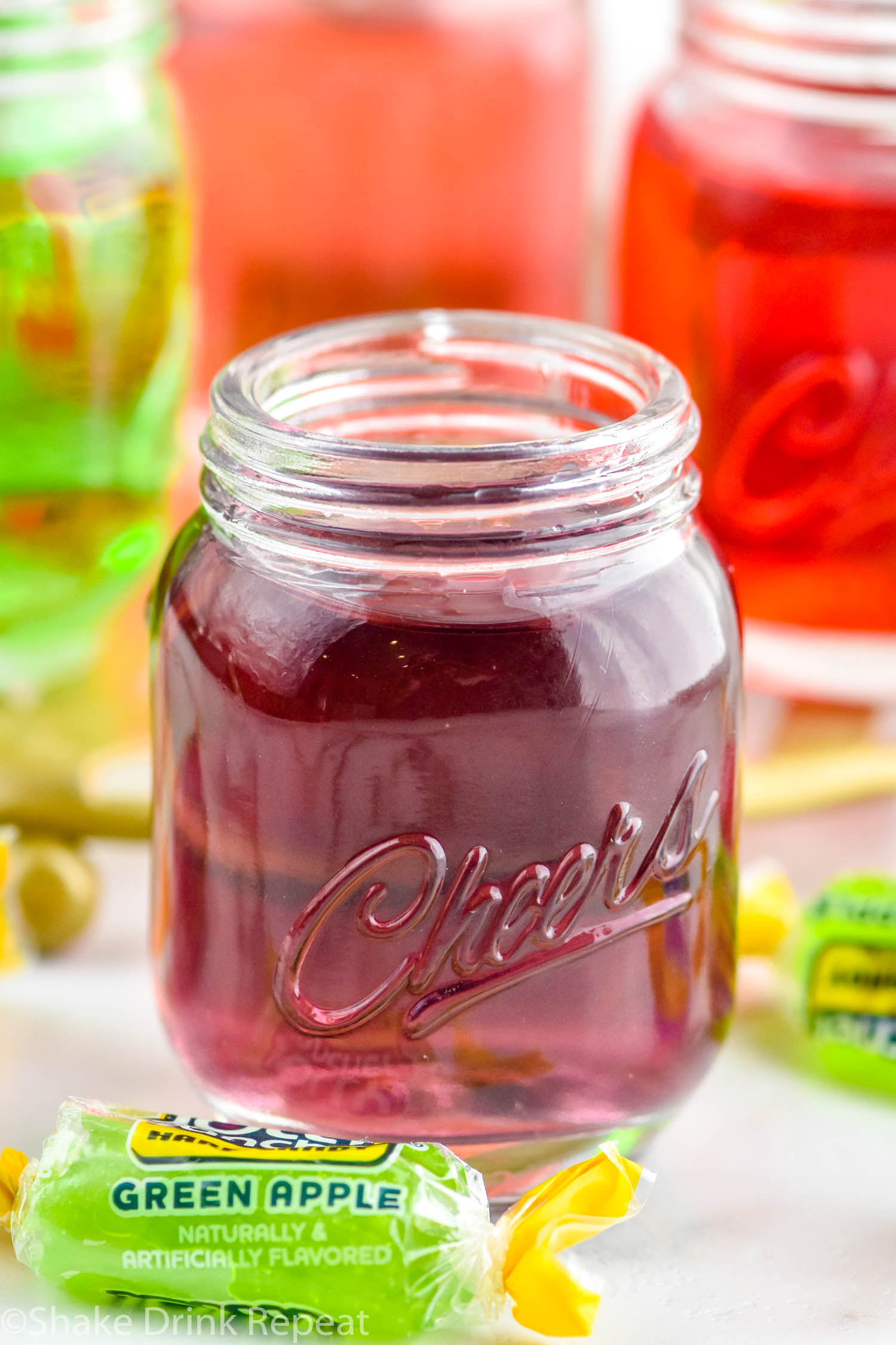 Photo of purple Jolly Rancher Shot with Jolly Rancher candies beside