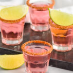 Mexican Candy Shots with salted rims and lime wedges