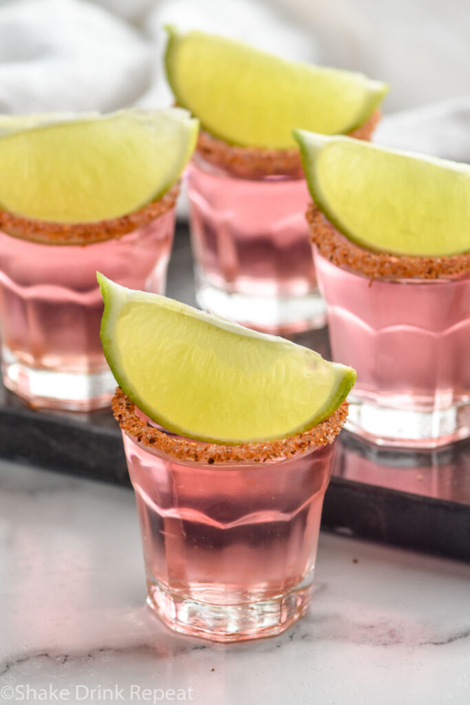 Mexican Candy Shots with lime wedges