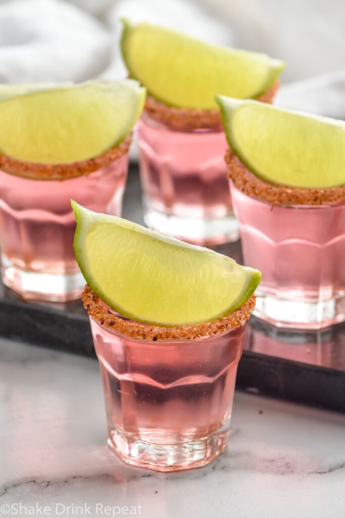 Mexican Candy Shots with lime wedges