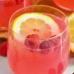 Pink Lemonade Vodka Punch with lemon slice and raspberries