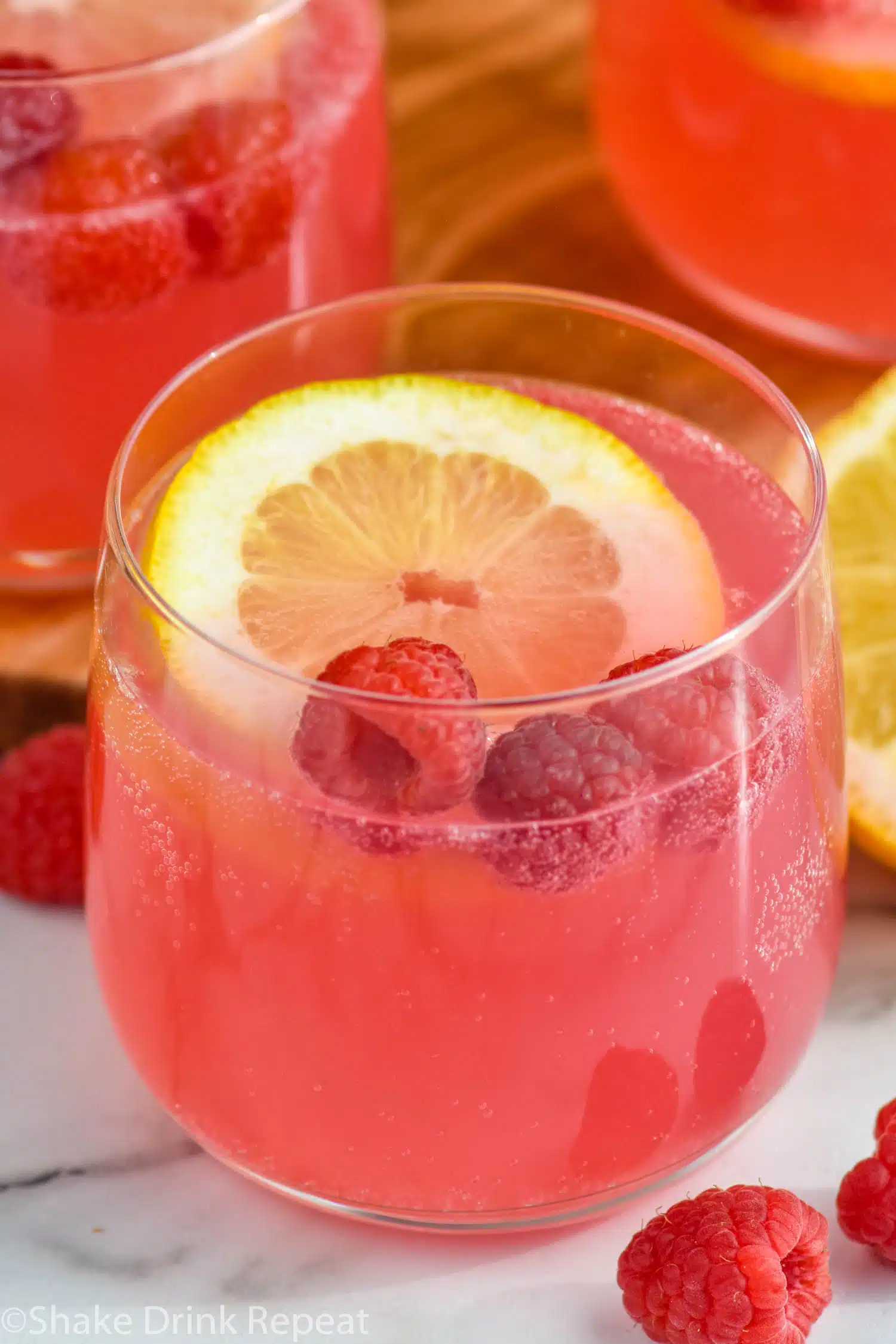 Pink Lemonade Vodka Punch with lemon slice and raspberries