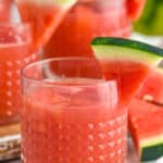 Watermelon rum punch garnished with slices of watermelon
