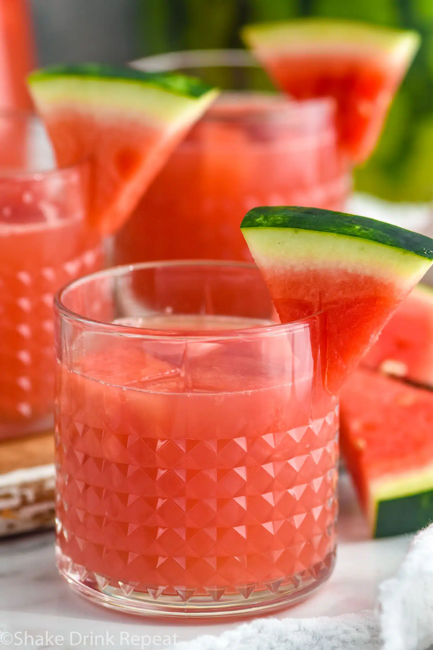 Watermelon rum punch garnished with slices of watermelon